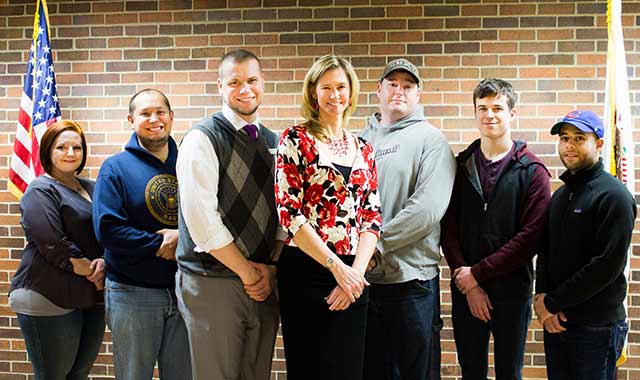 Robin Doeden, shown with a few of the military veterans who have received help in obtaining books and laptops for their education at McHenry County College, thanks to the McHenry County Community Foundation. From Left: Kati Beck, U.S. Air Force (Ret.); Jesus Gelly, U.S. Navy; Jason Memmen, Army National Guard; Doeden; Scott Winchester, U.S. Army Reserve; Jace Fuchs, U.S. Army; Steve Czarnecki, U.S. Navy.